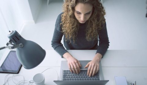 woman typing on laptop